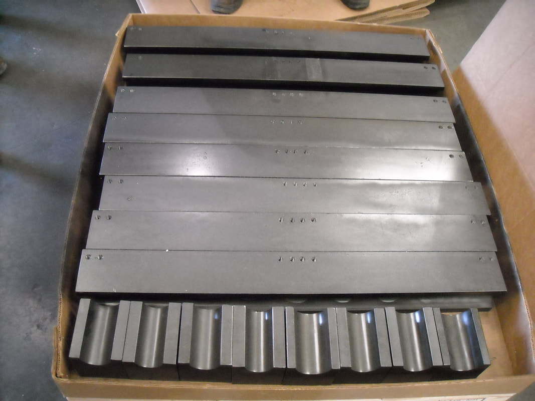 Custom made slide bars and clamp blocks for bending boiler tubing.