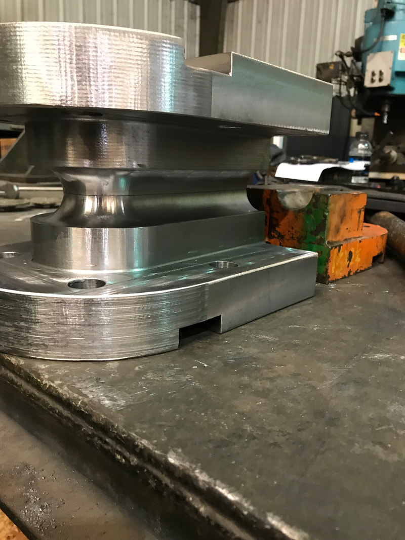 Undersized bend tooling for tighter radius bends on boiler tubing.